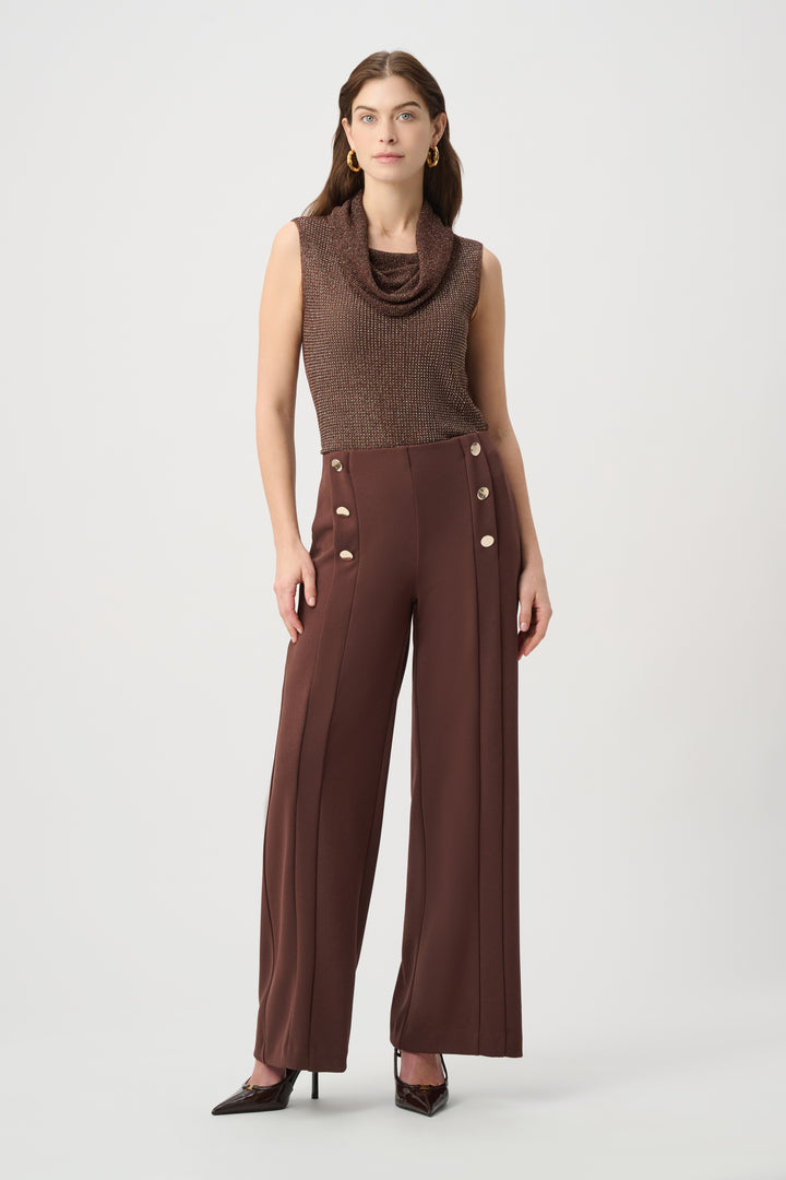 Woman wearing a brown sleeveless top and wide-leg pants on a white background