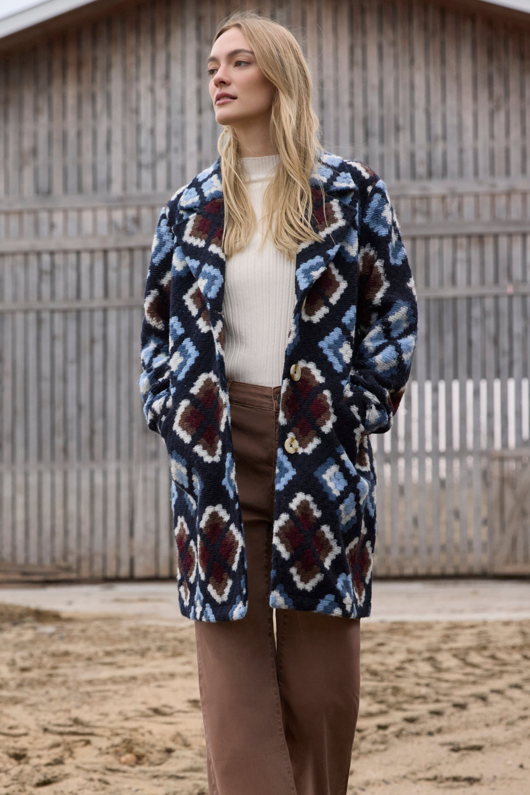 Charlie B Fall 2025 
Featuring a playful unlined crochet knit in a stylish diamond pattern, this long winter coat brings warmth with breathability.