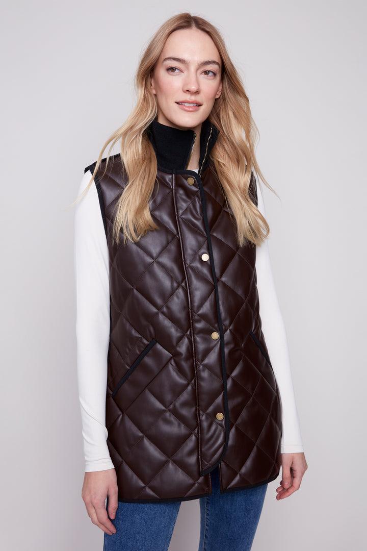 Charlie B Fall 2025 
 This long, quilted design exudes sophistication and elegance. The chic faux leather exterior, along with the front zipper and pockets, adds a touch of practicality to any outfit. 