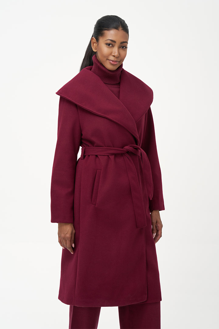 M Italy Fall 2025 
Designed with a chic yet simple aesthetic, it fastens securely with a matching robe belt for a tailored fit. Practical side seam pockets blend seamlessly into the design, providing discreet storage without disrupting the coat’s streamlined look.