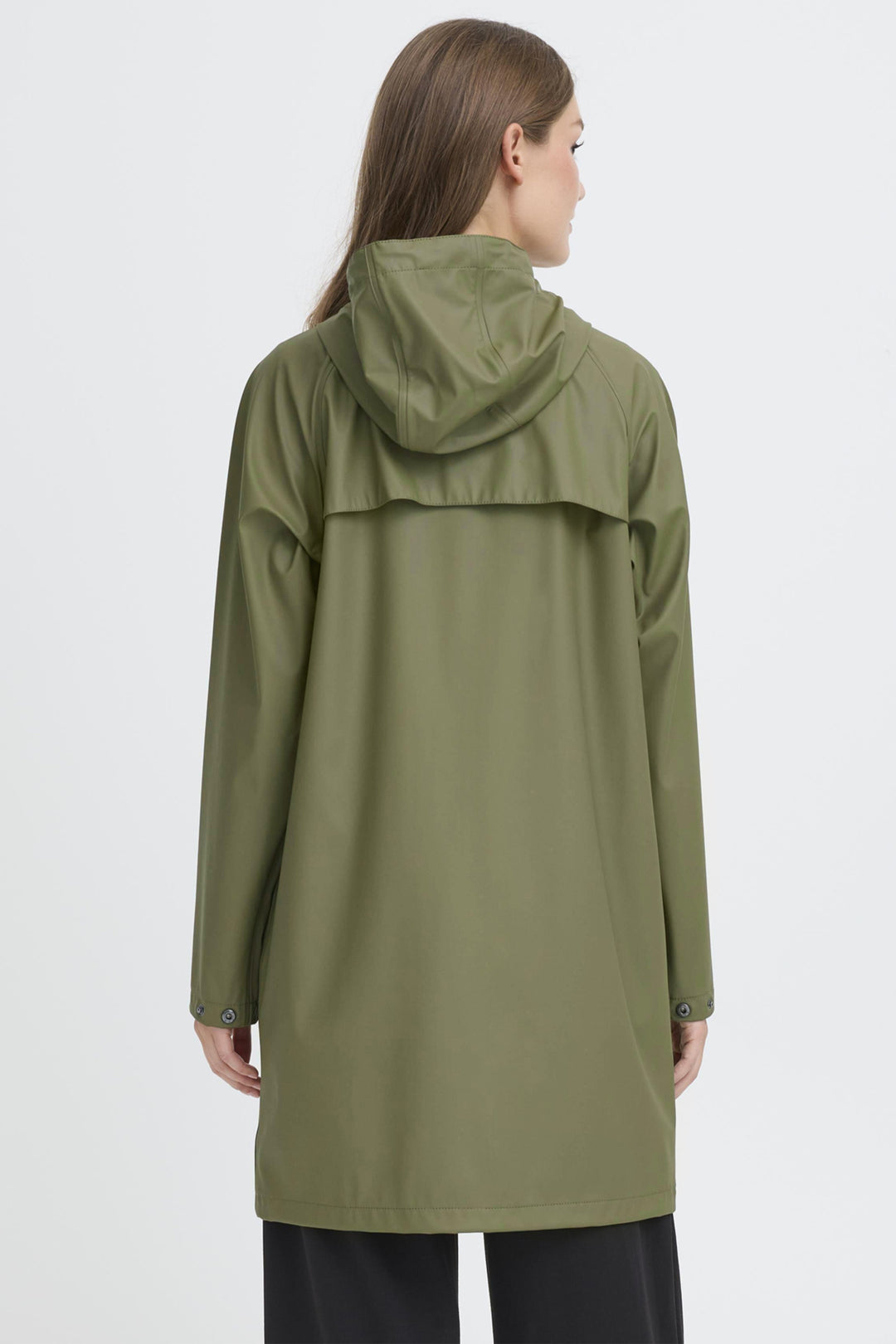 Person wearing a green raincoat on a white background