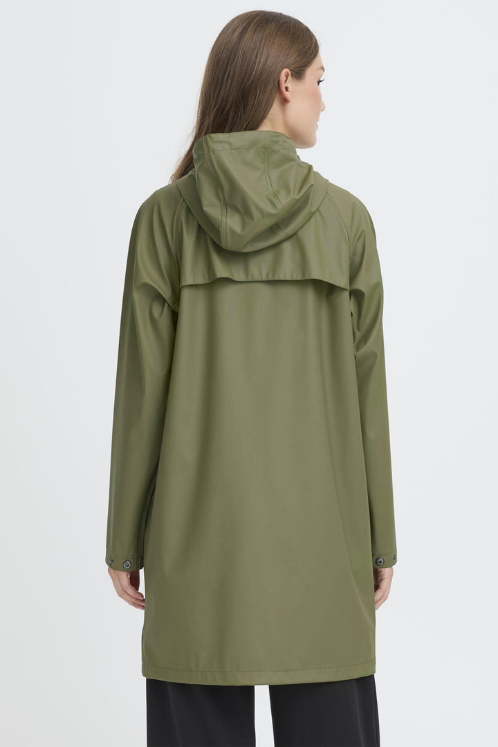 Person wearing a green raincoat on a white background