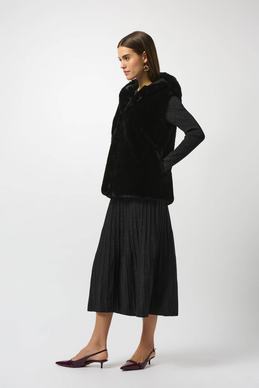 Woman wearing a black coat and skirt on a white background