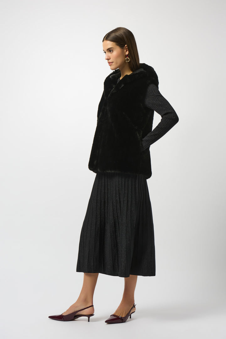 Woman wearing a black coat and skirt on a white background