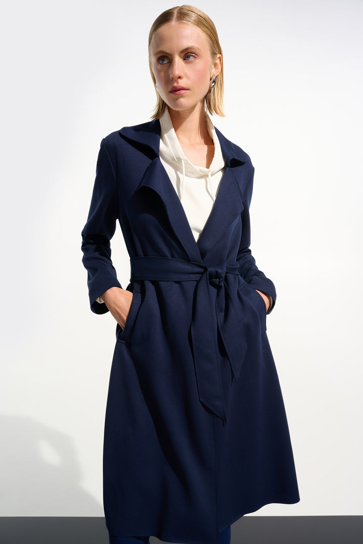 Woman wearing a navy blue coat over a white shirt on a white background