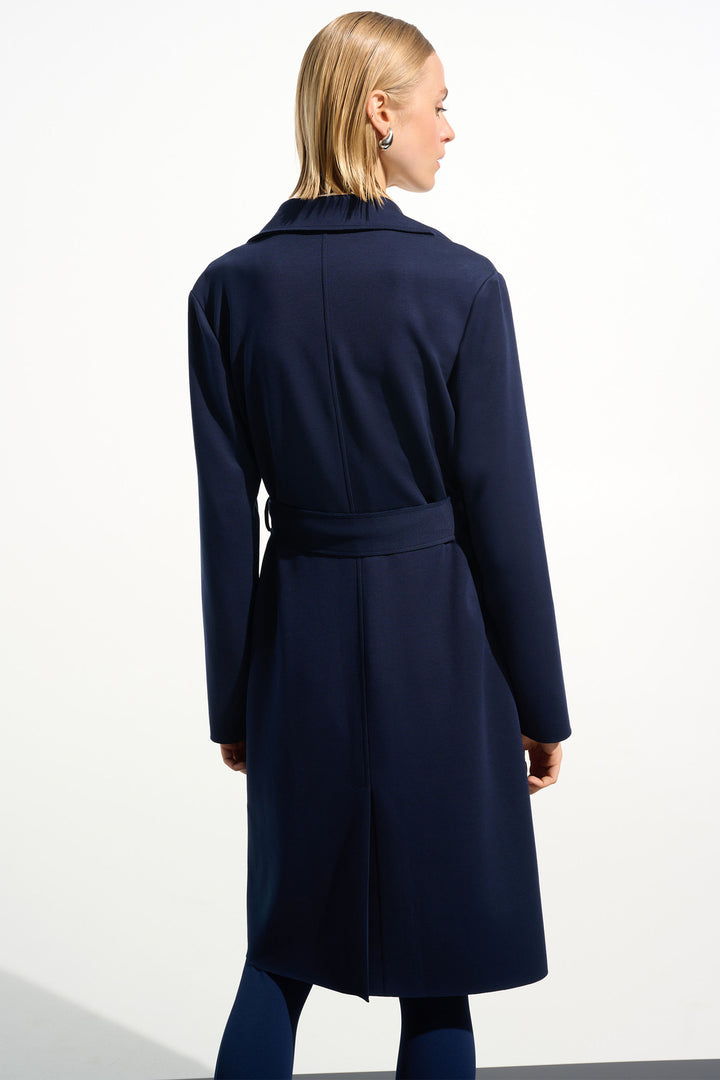 Woman wearing a navy blue coat on a white background