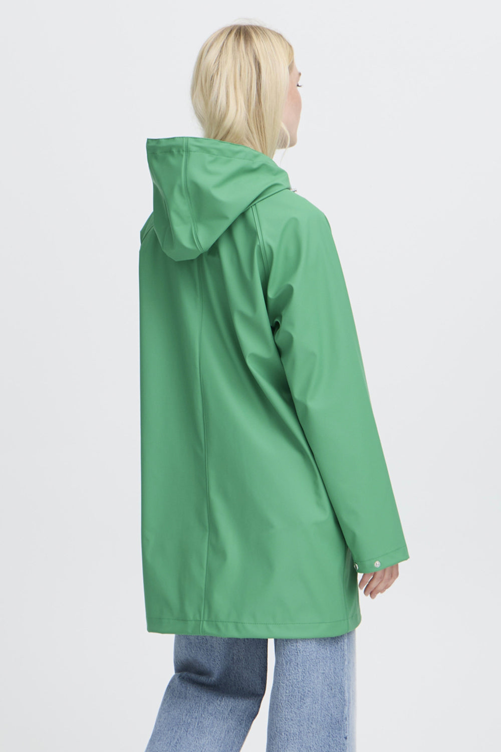 Person wearing a green raincoat on a white background