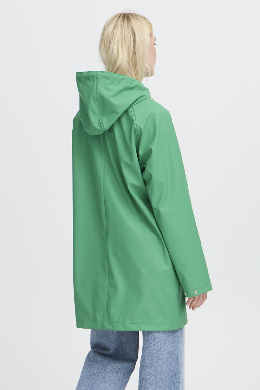 Person wearing a green raincoat on a white background