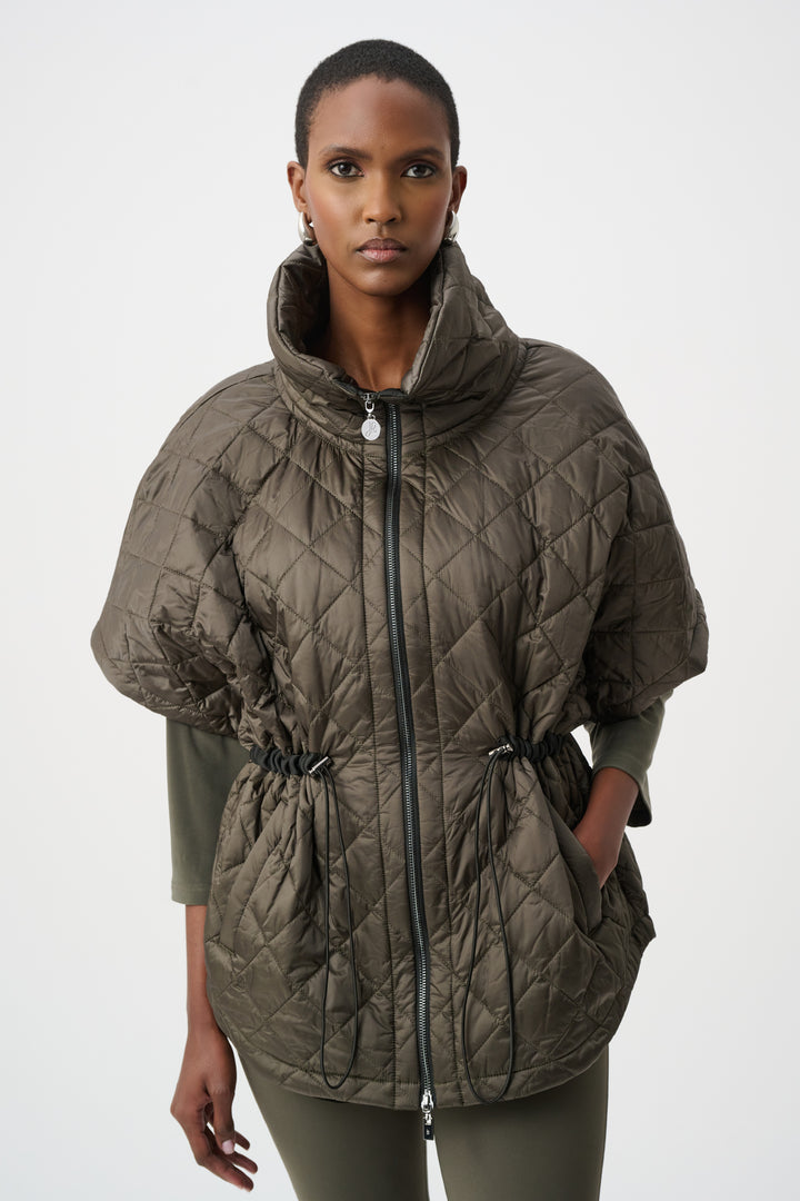 Woman wearing a quilted green vest coat on a white background