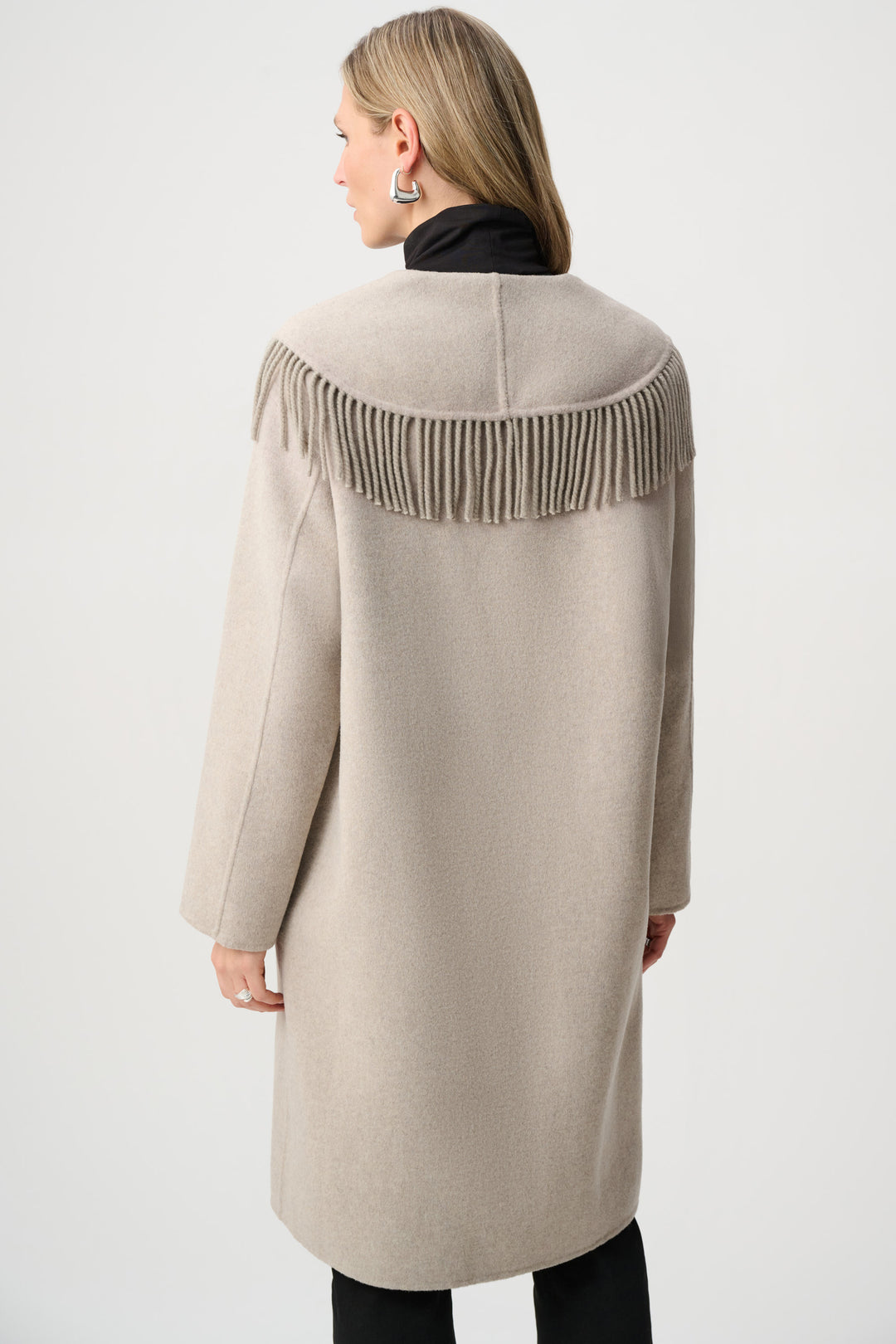 Beige coat with fringe details on a white background
