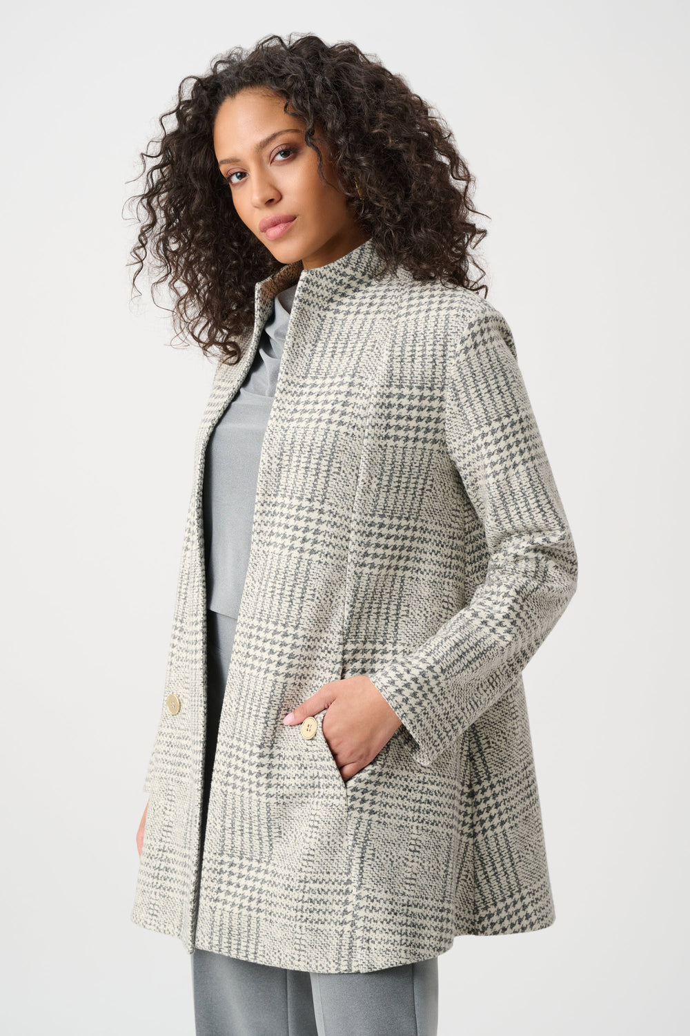 Woman wearing a checkered coat on a white background