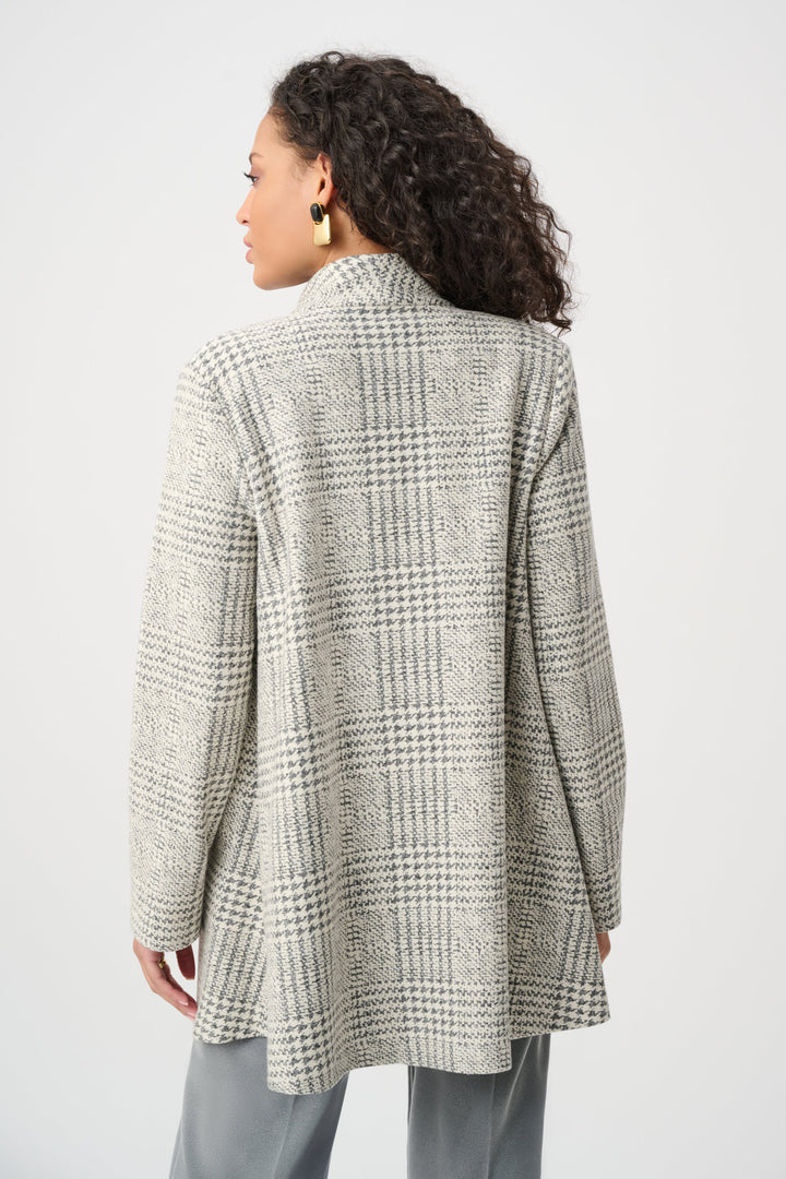 Person wearing a plaid coat on a plain background