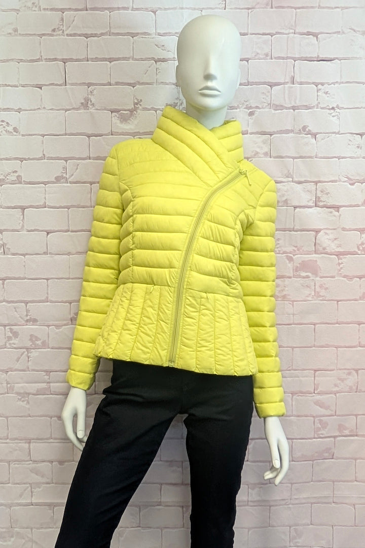 A bright yellow quilted puffer jacket with an asymmetrical zipper and high stand collar, displayed on a white mannequin torso against a light pink brick wall.