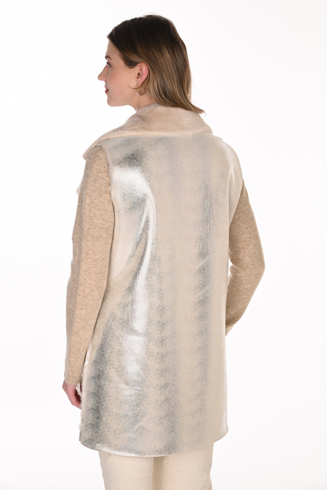 A woman shown from the back wearing a silver and cream long vest standing in front of a light grey background. 
