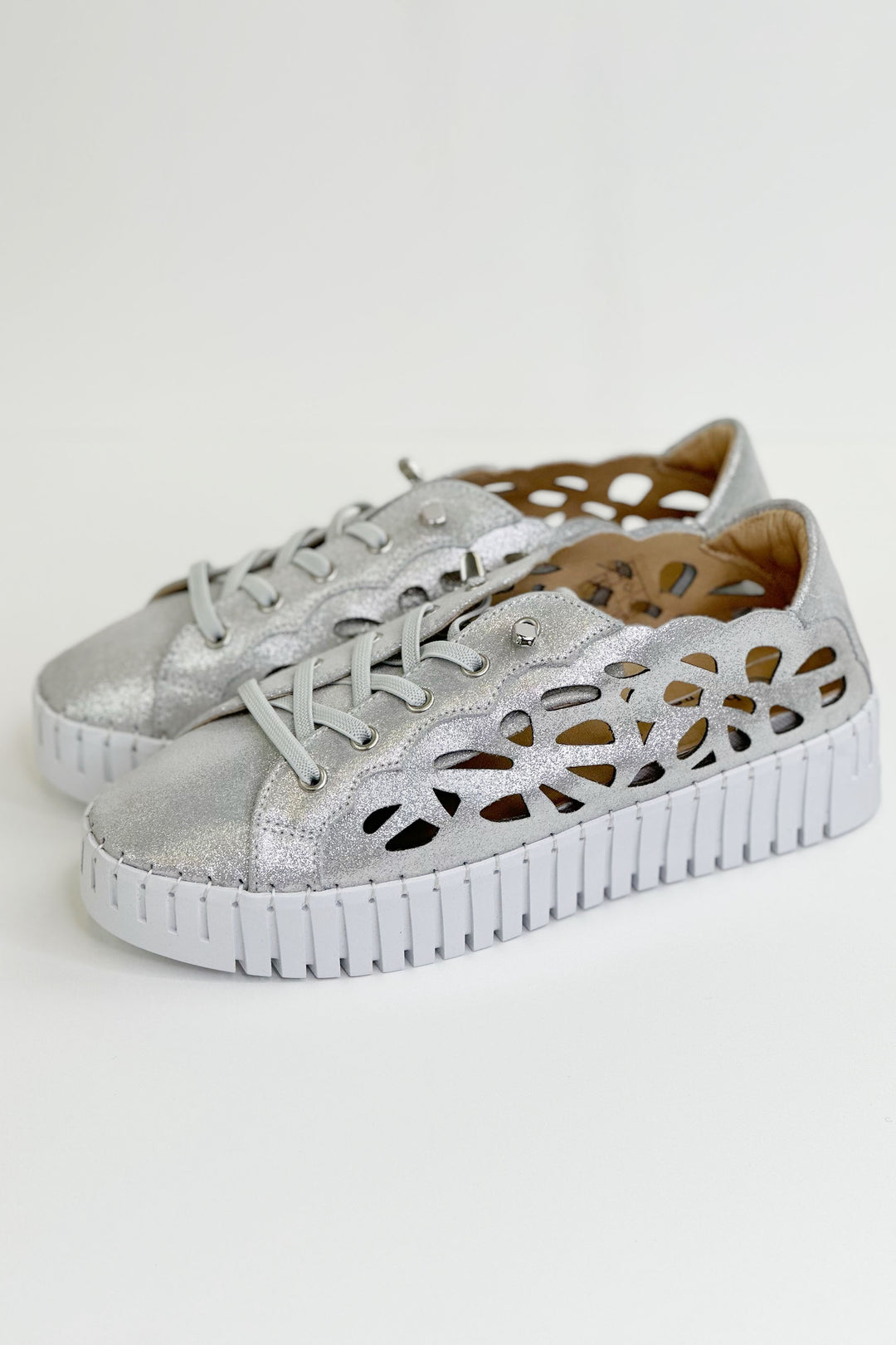 Bernie Mev Spring 2024 This stunning slip-on sneaker features a stretchy knit upper,<span data-mce-fragment="1"> sparkle shine finish</span><span data-mce-fragment="1">,</span><span data-mce-fragment="1"> eyelet</span> siding design pattern, lace up details and Bernie Mev’s signature memory foam footbed.