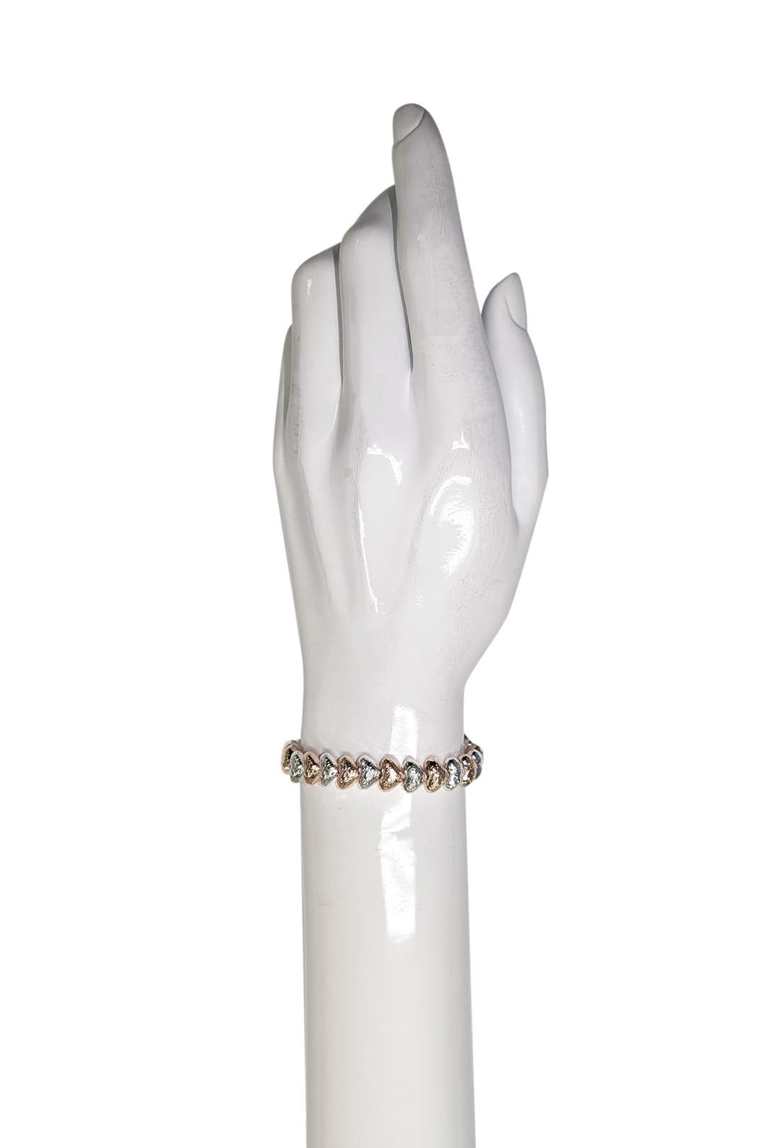 Glittering hearts bracelet on a wrist.