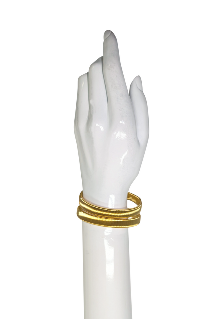 Sleeve garter on wrist on a white backdrop. 