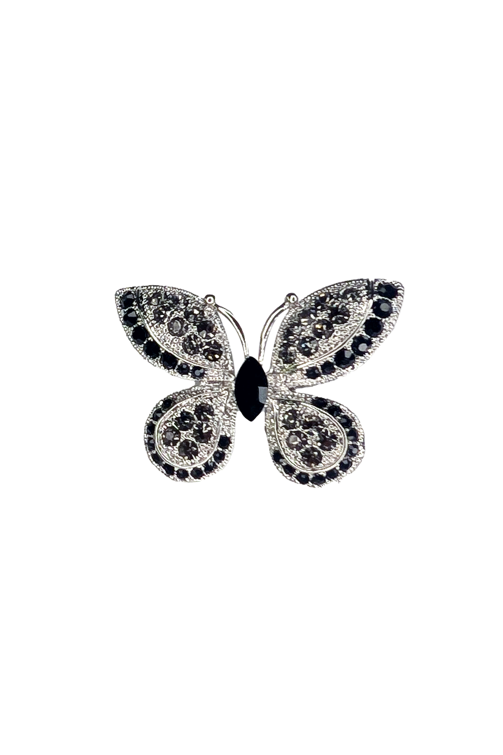 Butterfly-shaped lapel pin with gemstones on a white background