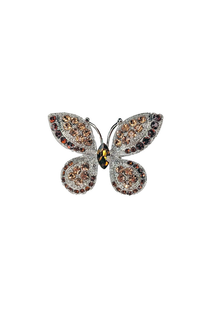 Butterfly-shaped lapel pin with gemstones on a white background