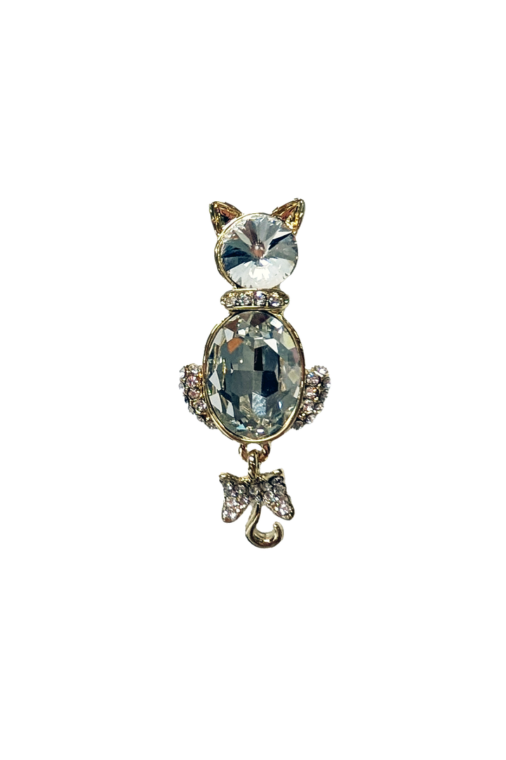Cat-shaped brooch with crystal-like gemstones on a white background