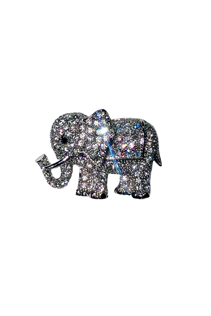 Silver elephant brooch with gemstones on a white background