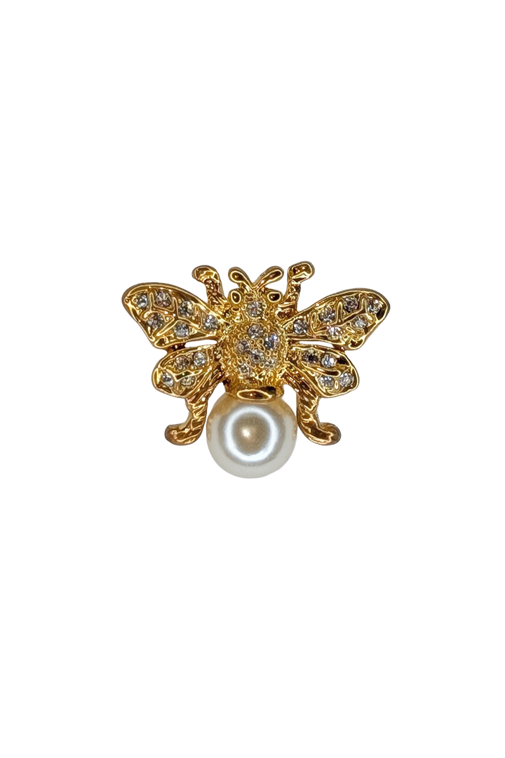 Gold Butterfly-shaped brooch with pearl center on a white background