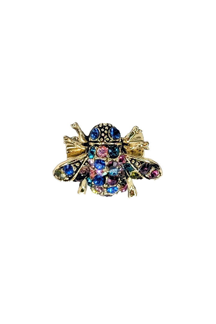 Multicolored gemstone bee brooch on a white background