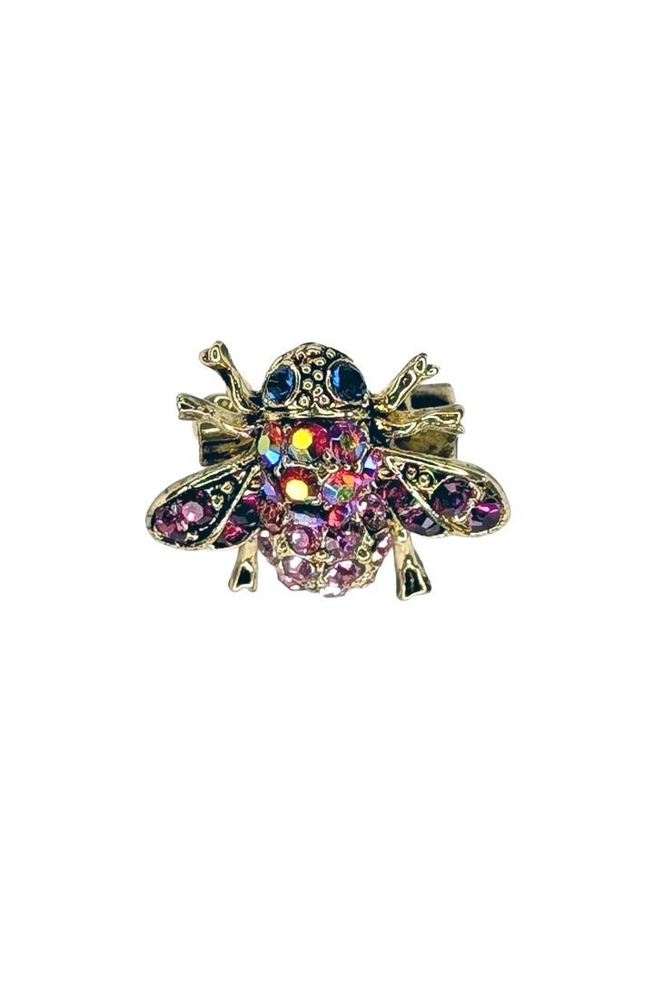 Multicolored jeweled bee lapel pin on a white background