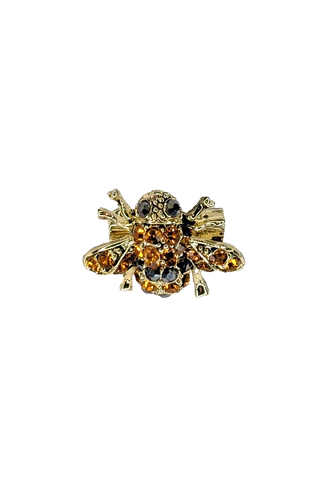 Gold bee-shaped brooch with gemstones on a white background