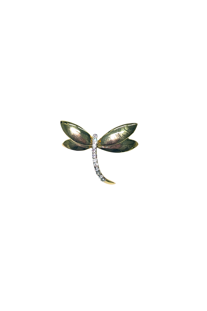 Dragonfly-shaped brooch with gemstones on a white background