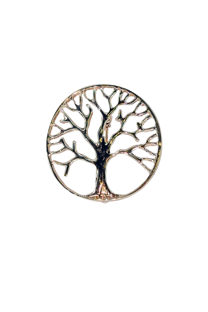 Decorative lapel pin with a tree design on a white background