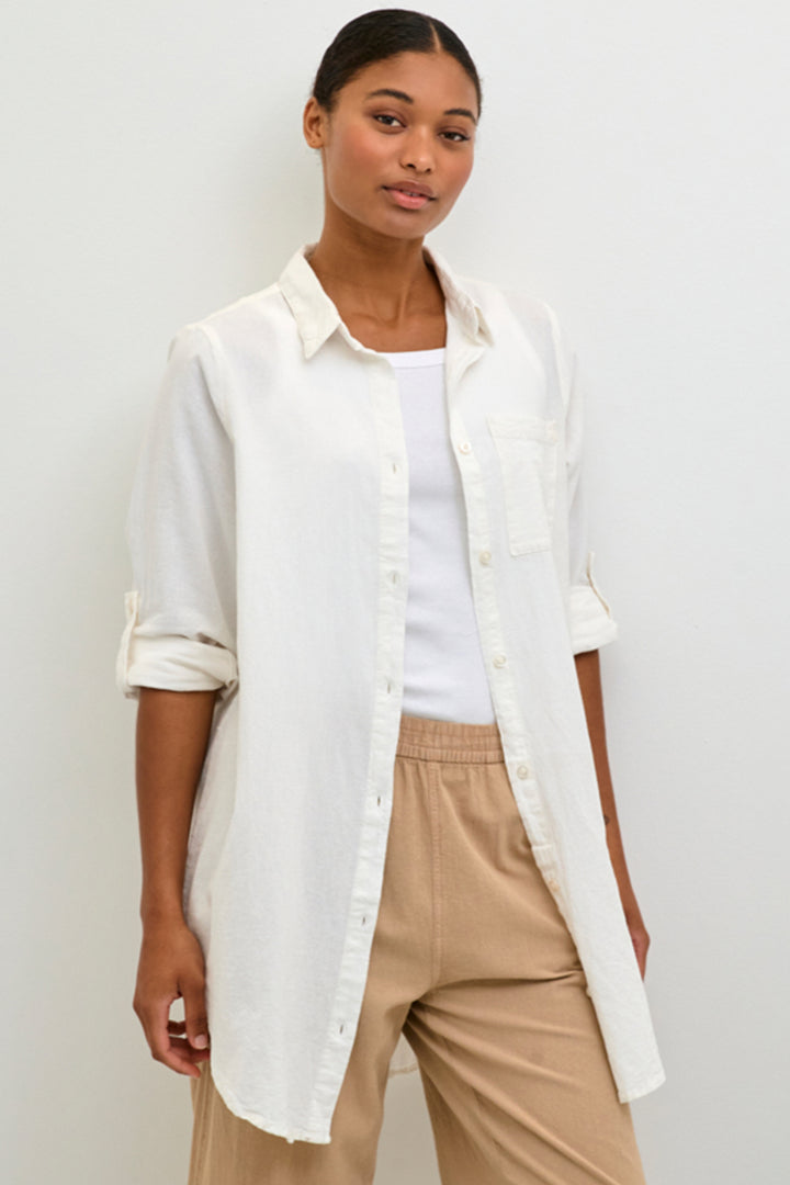 With a relaxed fit and classic blouse style, this all cotton tunic top features full front buttons and button cuffs.