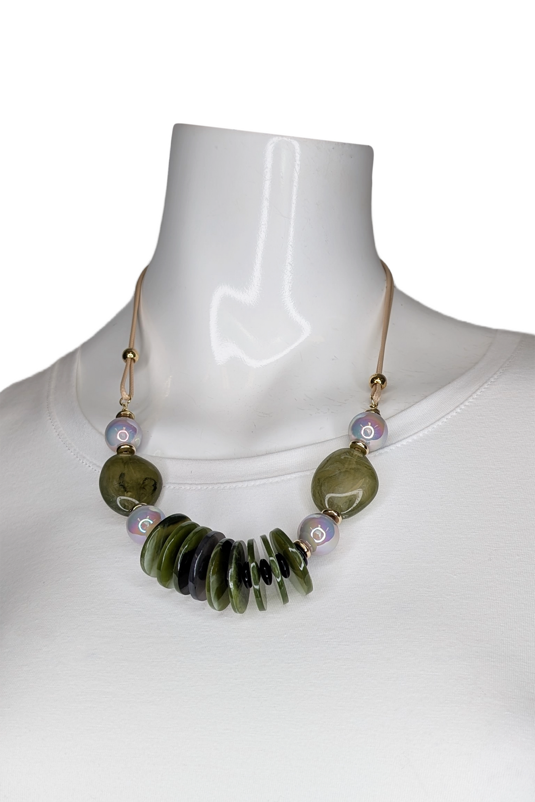 Necklace with green beads on a mannequin against a white background