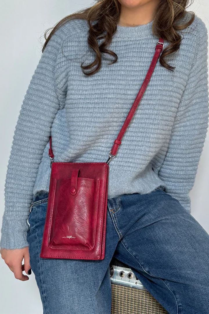 ESPE Fall 2025 
 The perfect accessory for any stylish individual! Made with slots for your cards, this classy cell phone bag and wallet is not only functional for you, but also makes a great gift idea! 