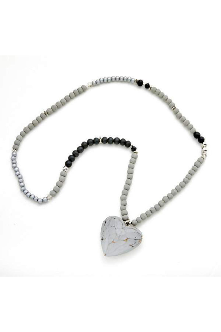 SUZIE BLUE Fall 2025 
Handcrafted with care, this wooden heart necklace combines natural charm with versatile style. Each piece features delicate beads and a beautifully carved wooden heart that pairs effortlessly with any outfit.