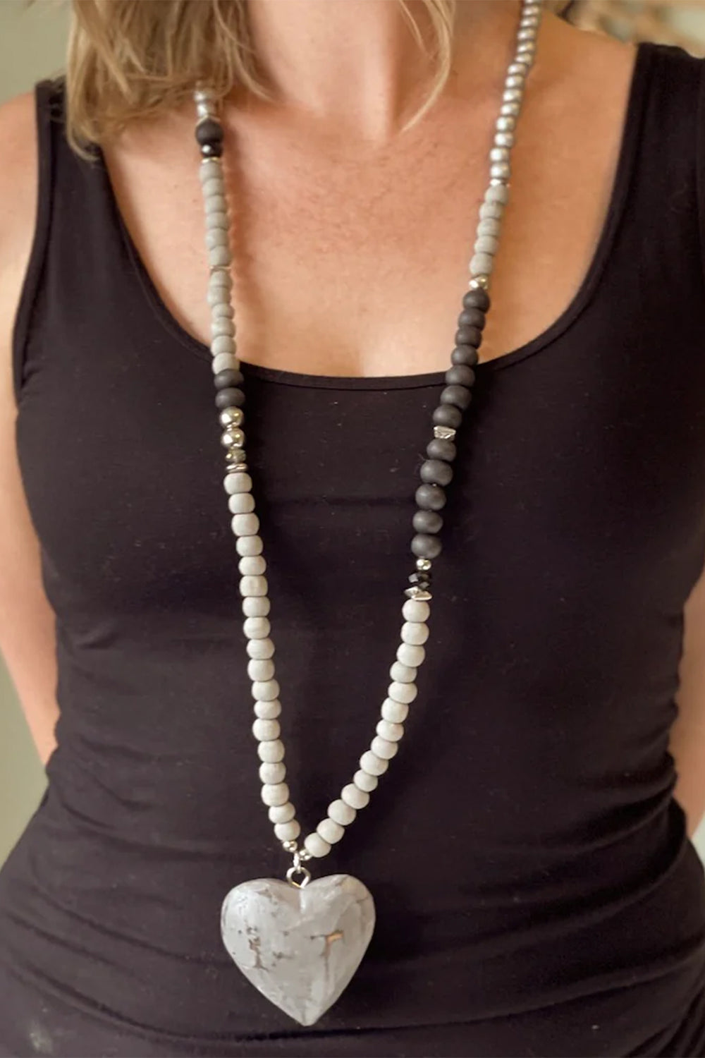 SUZIE BLUE Fall 2025 
Handcrafted with care, this wooden heart necklace combines natural charm with versatile style. Each piece features delicate beads and a beautifully carved wooden heart that pairs effortlessly with any outfit.