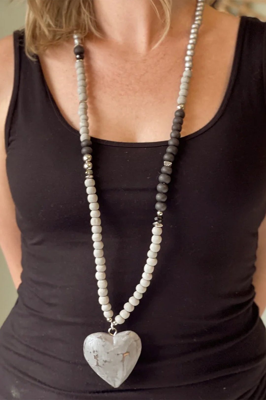 SUZIE BLUE Fall 2025 
Handcrafted with care, this wooden heart necklace combines natural charm with versatile style. Each piece features delicate beads and a beautifully carved wooden heart that pairs effortlessly with any outfit.