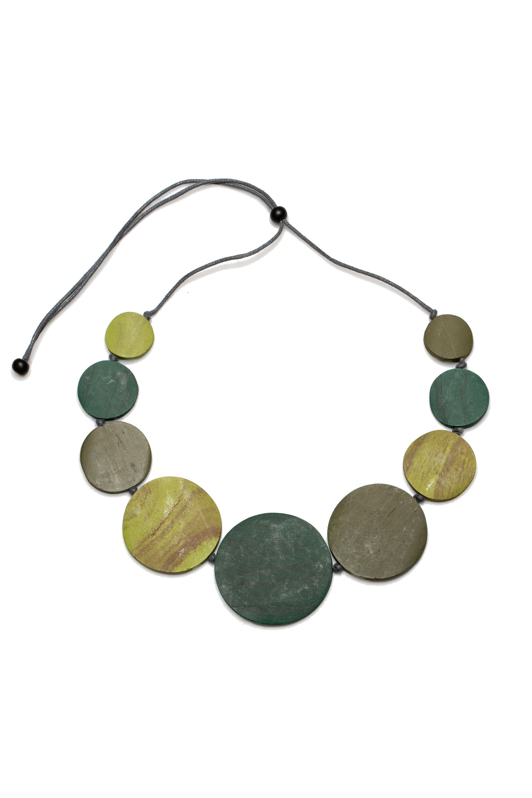 Necklace with round green and yellow beads on a white background