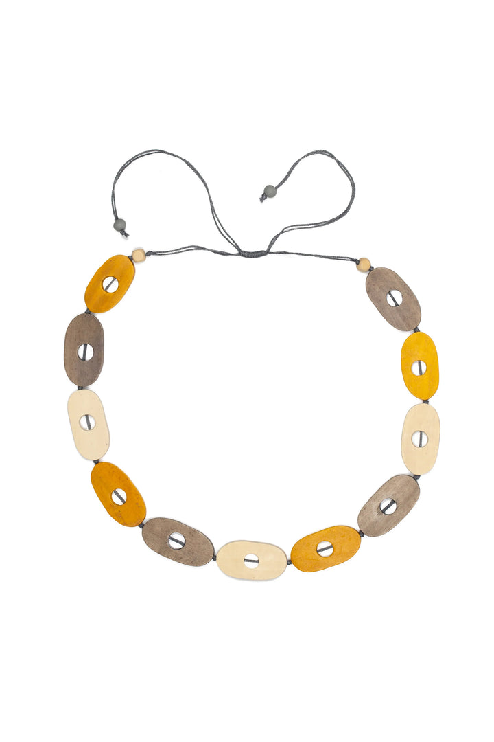 Necklace with oval-shaped beads in yellow tones on a white background