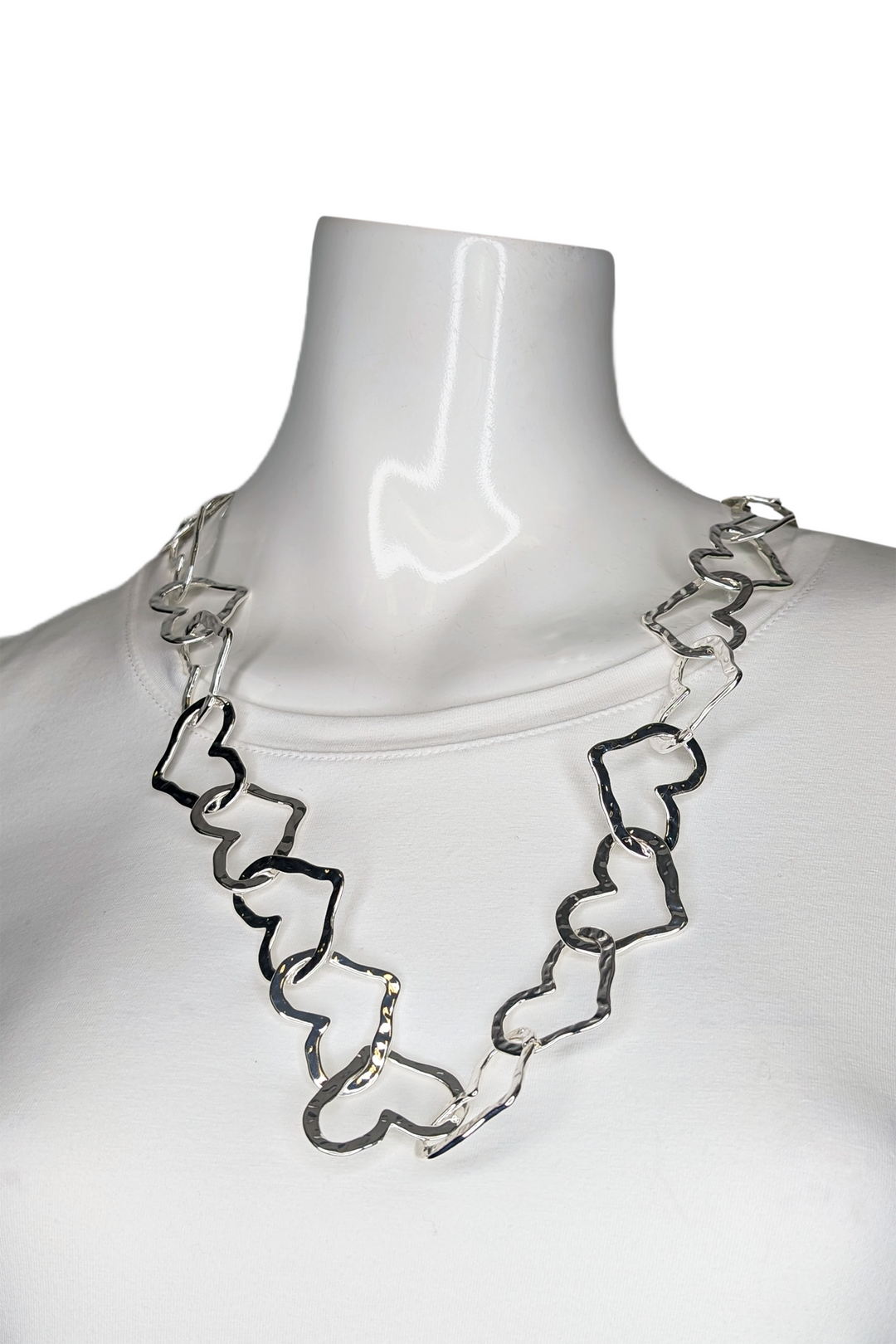 Silver chain necklace on a mannequin against a white background