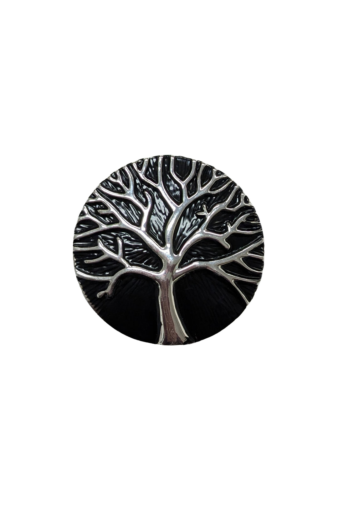 Silver tree broach on a black background