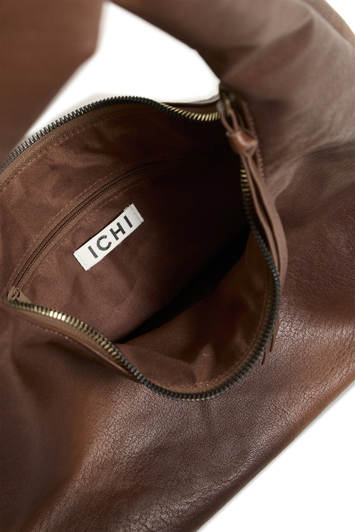 Brown leather bag with a visible Ichi brand logo on a white background