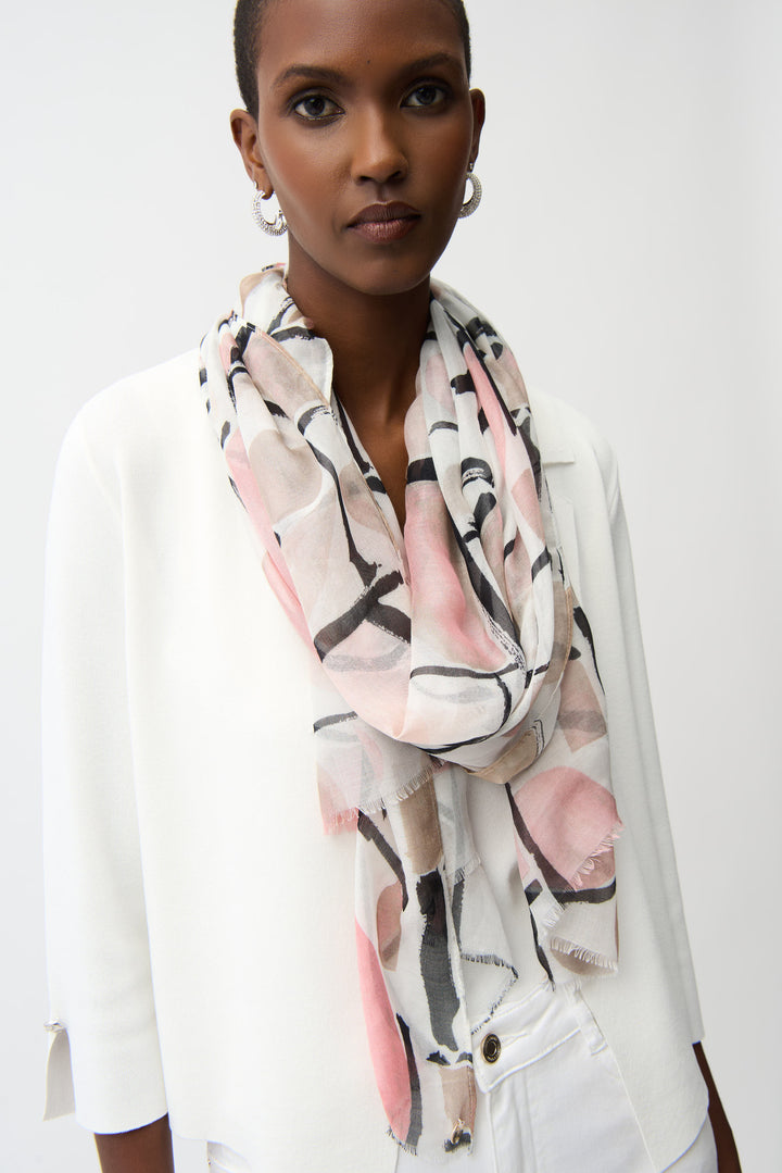 Woman wearing a colorful light scarf with abstract patterns on a white background