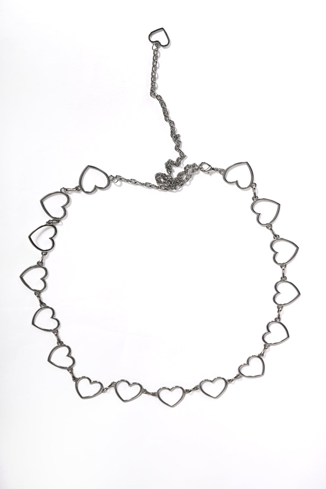 Silver heart-shaped belt on a white background