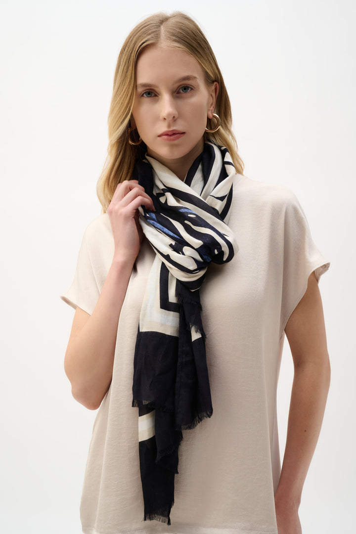 Woman wearing a black and white patterned scarf on a white background