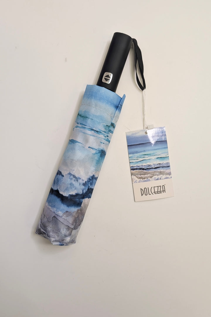 Foldable umbrella with watercolor design and Dolcezza tag on a light gray background