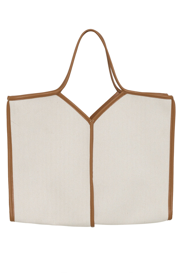 White tote bag with brown straps on a white background