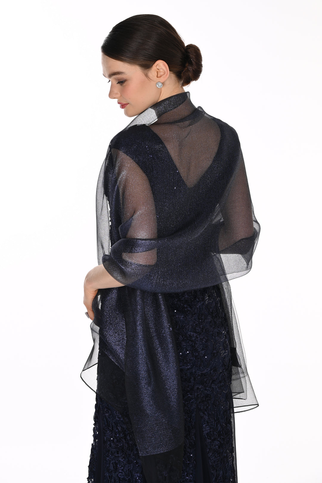 A woman shown from the back wearing a dark navy sheer mesh shawl draped over a dark navy embellished dress, against a plain white background.