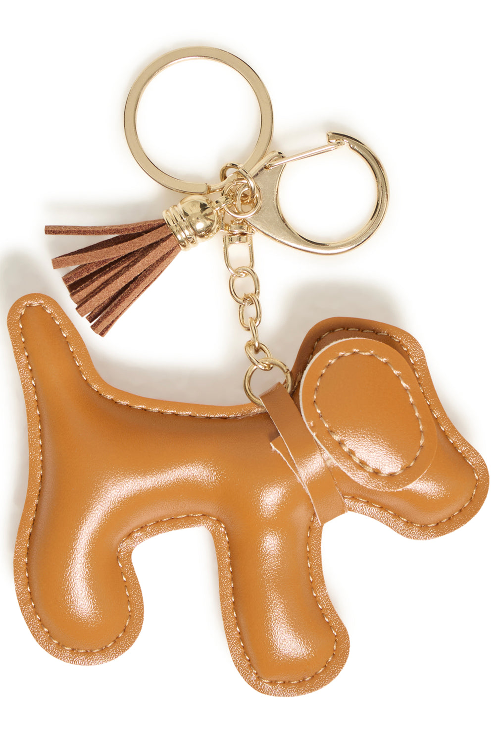 A tan leather dog-shaped keychain with gold-tone metal hardware, a matching leather tassel, and a split key ring, shown on a plain white background.