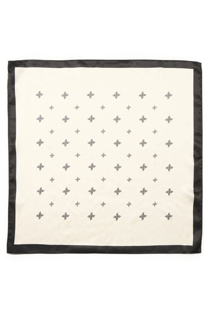 A square scarf with a cream-colored center, a black border, and a grid pattern of small gray crosses and stars.